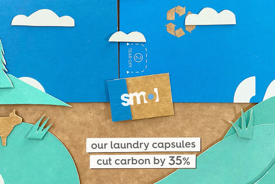 landcape made from cardboard packaging with text smol laundry capsules cut carbon by 35%